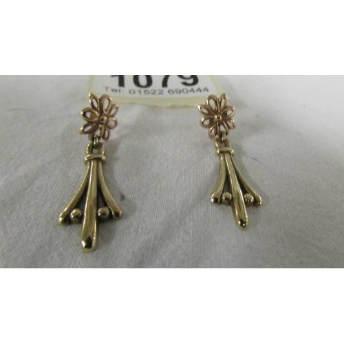 1079 - A pair of 9ct gold pendant earrings.