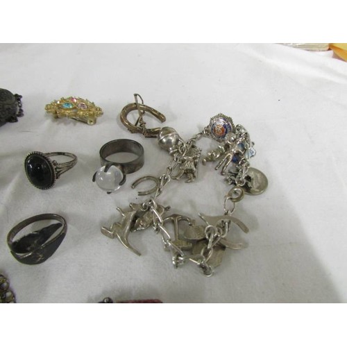 1087 - A mixed lot including charm bracelet with some silver charms, 2 cameo brooches, 2 silver rings etc.,