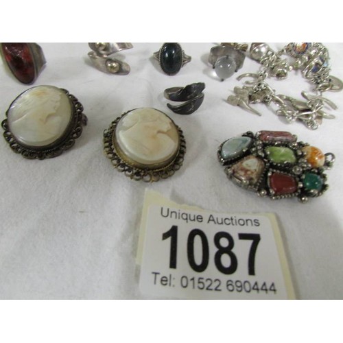 1087 - A mixed lot including charm bracelet with some silver charms, 2 cameo brooches, 2 silver rings etc.,