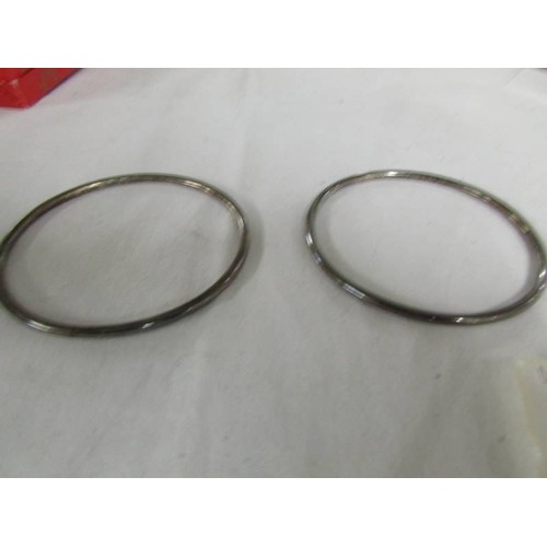 1090 - Three silver bangles, 103 grams.