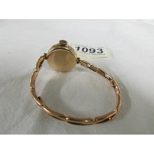 1093 - A 9ct gold cased wrist watch on a 9ct gold bracelet, total weight 13.8 grams.