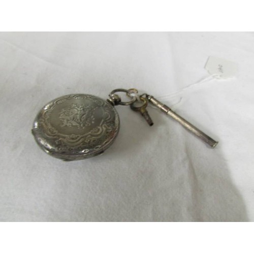 1111 - A silver fob watch with key and a silver toothpick.