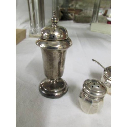 1112 - A silver three piece condiment set and a silver pepperette.