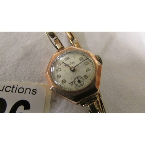 1126 - An art deco 9ct gold cased Majex ladies wrist watch on 9ct gold strap, in working order. Small dents... 