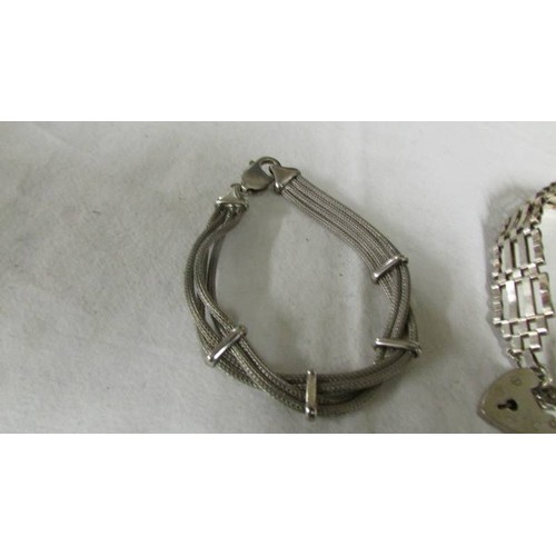 1140 - A silver gate bracelet and two other silver bracelets.