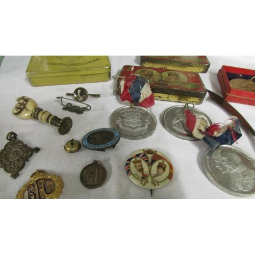 1145 - A mixed lot including commemorative tins, medals and badges.