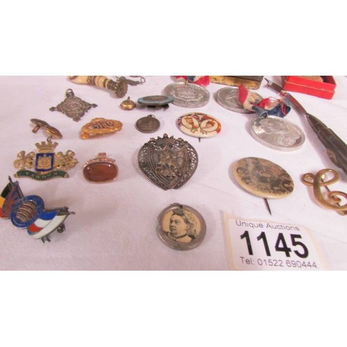 1145 - A mixed lot including commemorative tins, medals and badges.