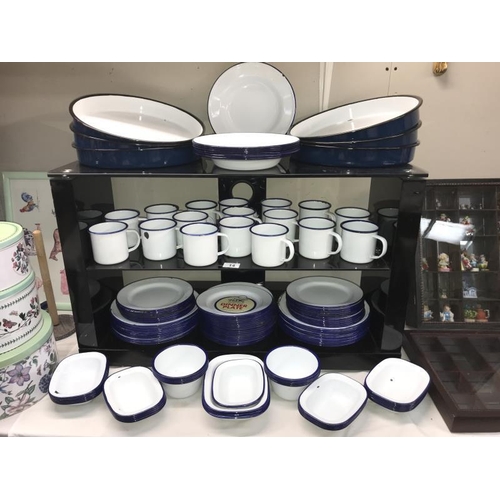 14 - A large quantity of blue and white Falcon enamel dinner ware including mugs, plates etc.