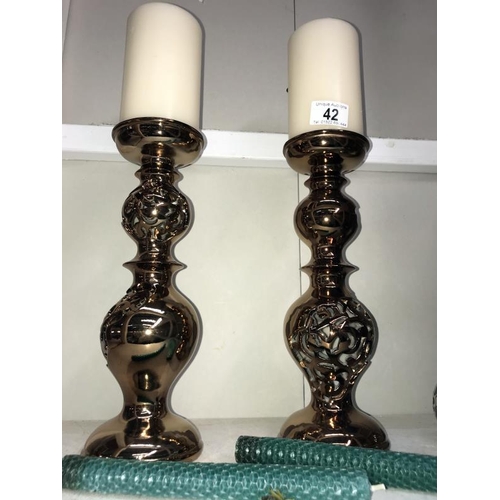 42 - A pair of lustreware candlesticks with pillar candles, 3 chrome tea light holders and pottery elepha... 