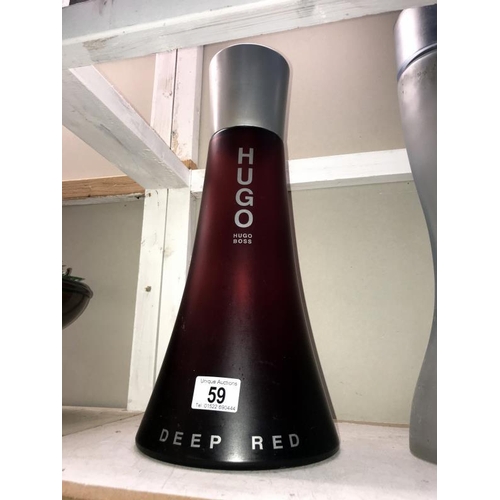 59 - A large Hugo Boss Deep Red perfumery/chemist shop display bottle, height 41cm, (the contents are not... 