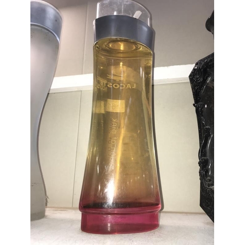 61 - A large Lacoste Touch Of Pink perfumery/chemist shop display bottle, height 40cm, (the contents are ... 