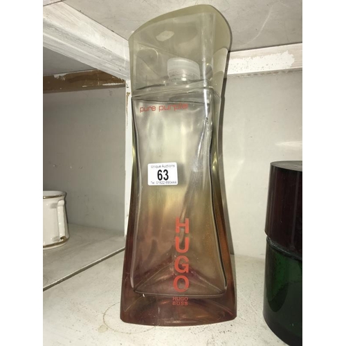 63 - A large Hugo Boss Pure Purple perfumery/chemist shop display bottle, height 34cm, (the contents are ... 