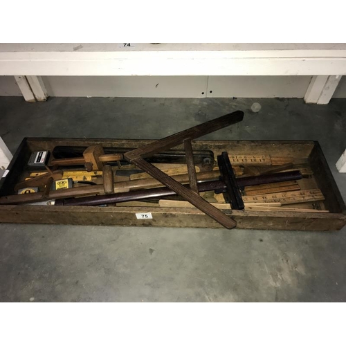 75 - An old wooden tray of vintage tools including rulers,  spirit level etc.