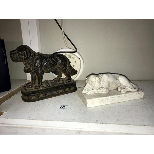 76 - A cast iron door stop of a St Bernard and a plaster laying down dog