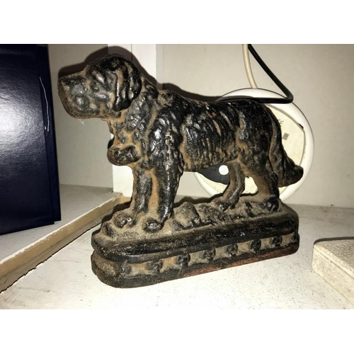 76 - A cast iron door stop of a St Bernard and a plaster laying down dog