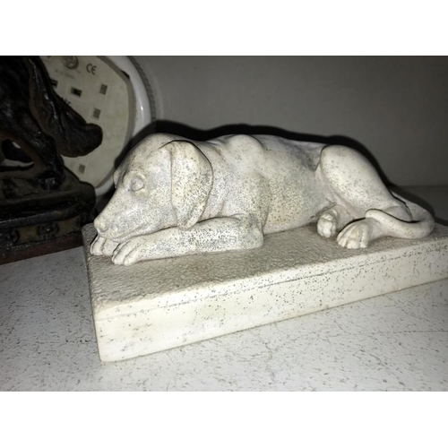 76 - A cast iron door stop of a St Bernard and a plaster laying down dog