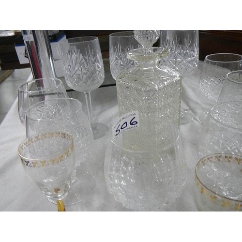 506 - A glass decanter, 6 cut glass drinking glasses and other glasses.