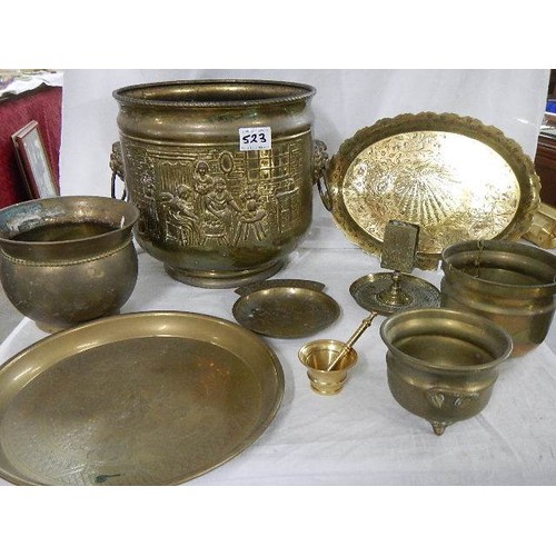 523 - An old embossed brass jardiniere and other brassware.