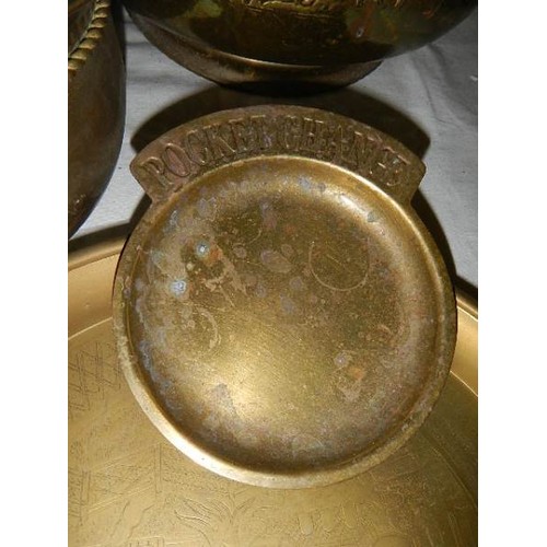 523 - An old embossed brass jardiniere and other brassware.