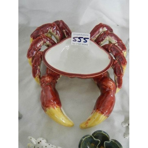 555 - A mixed lot including majolic crab dish, dog etc.,