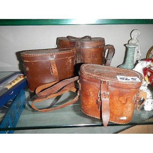 565 - Three old leather binocular cases.