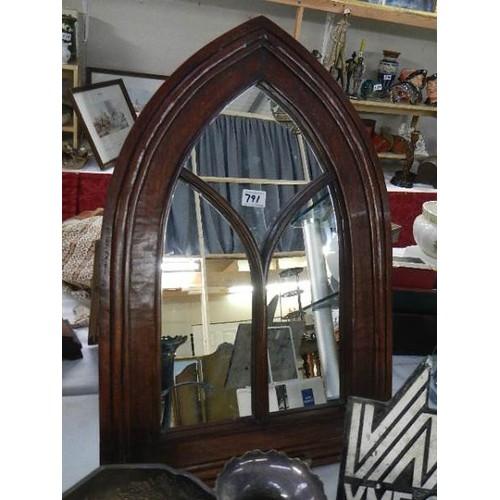 791 - A wood framed arched mirror.