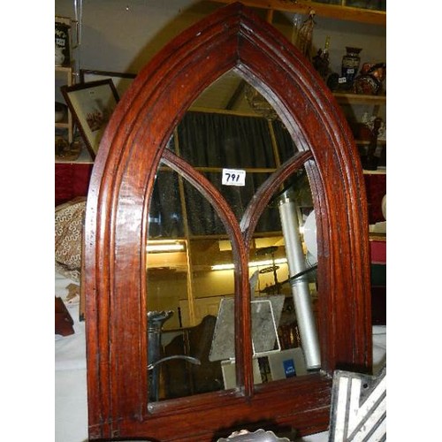 791 - A wood framed arched mirror.