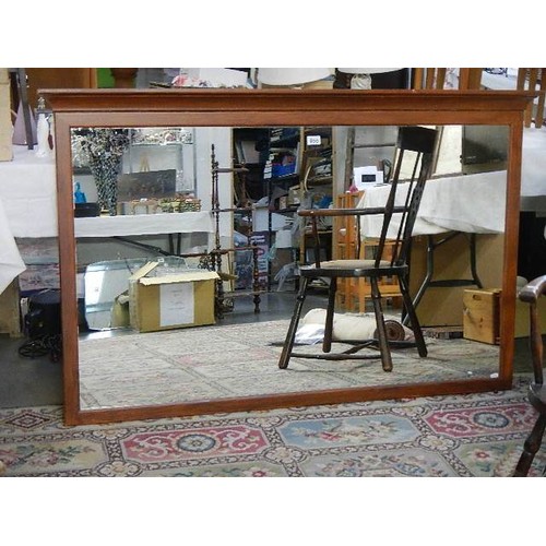 800 - A long mahogany shop mirror.