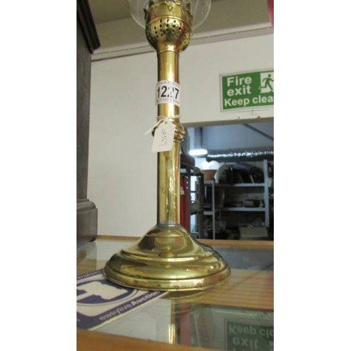 1227 - A brass candle lamp with glass chimney.