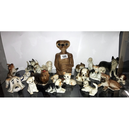 100 - A large selection of pottery dog ornaments including an E.T. money box