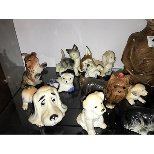 100 - A large selection of pottery dog ornaments including an E.T. money box