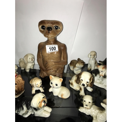 100 - A large selection of pottery dog ornaments including an E.T. money box