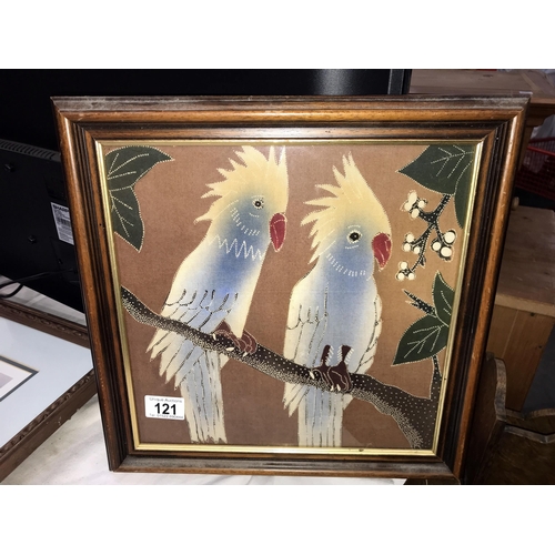 121 - A framed silk picture of 2 cockatoo parrots (36cm x 36cm)