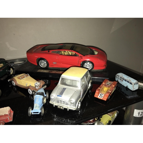 128 - A quantity of die cast model cars & quantity of books mainly on cars (2 shelves)