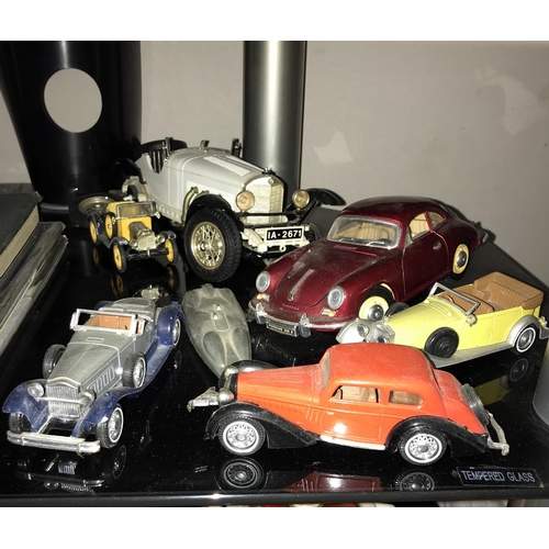 128 - A quantity of die cast model cars & quantity of books mainly on cars (2 shelves)