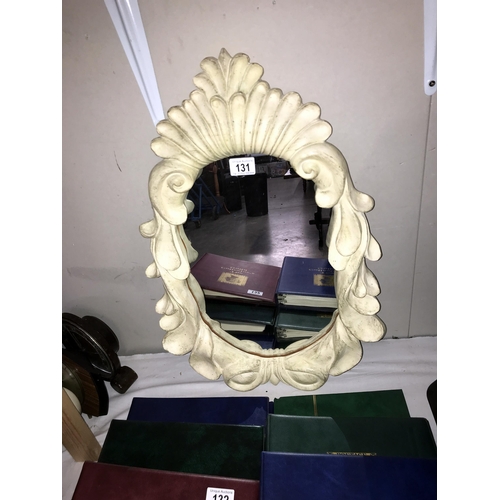 131 - An ornate resin framed mirror (40cm x 60cm) (COLLECT ONLY)