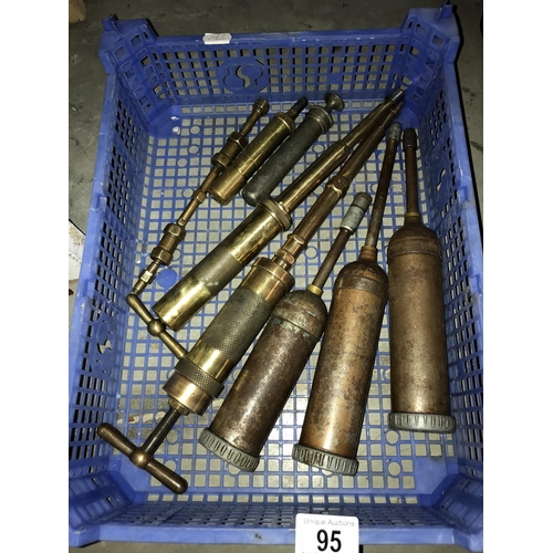 95 - A quantity of vintage grease guns including some brass examples