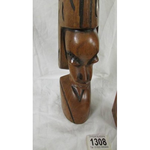 1308 - A pair of good quality carved hardwood tribal heads.