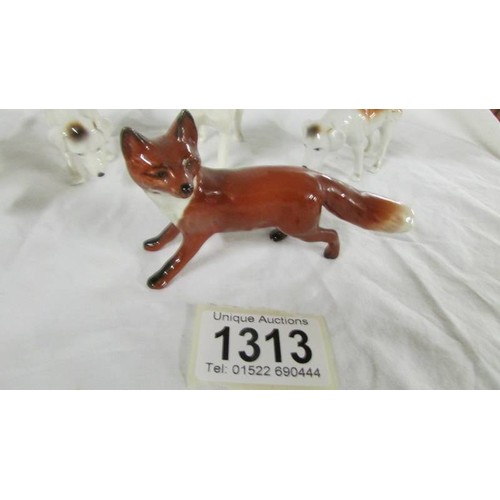 1313 - Four Beswick hounds and a Beswick fox.