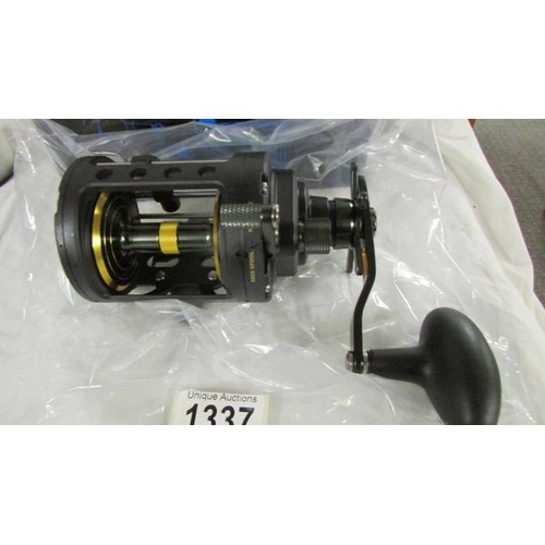 1337 - A boxed PENN Fathom level wind fishing reel.