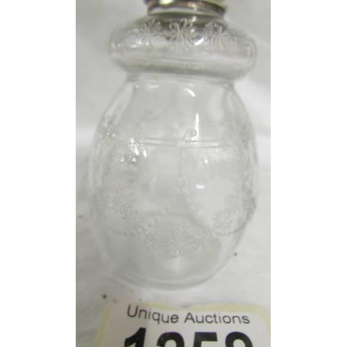 1258 - A pretty engraved glasss silver topped scent bottle.