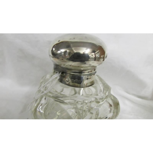 1259 - A heavy glass scent bottle with silver top.