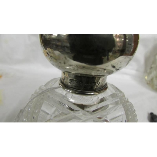 1260 - A cut glass scent bottle with silver top. Birmingham 1904.