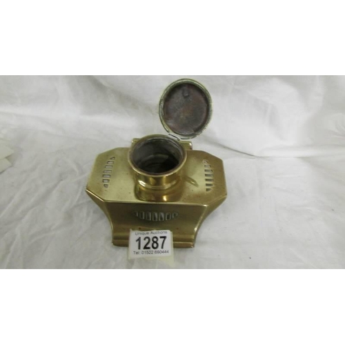 1287 - A brass inkwell (missing liner).