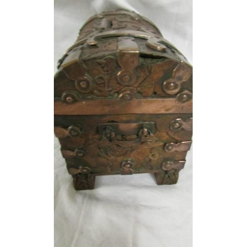 1289 - An intricately carved wooden money box with metal mounts in the arts and crafts style, dated London ... 