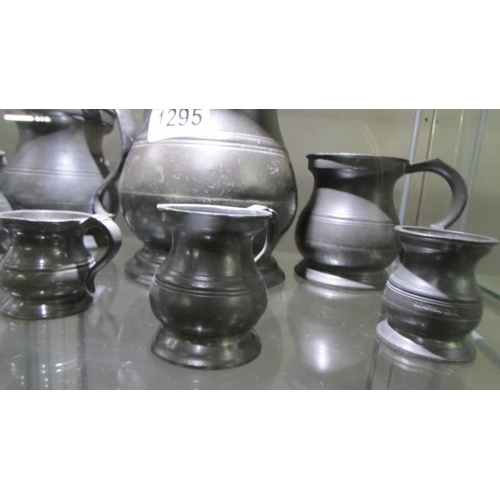 1295 - A set of seven antique pewter measures by James Yeates.