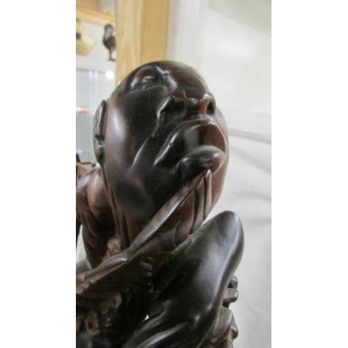 1395 - A good quality carved hardwood figure, 55 cm tall.