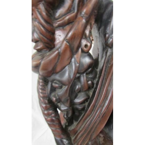 1395 - A good quality carved hardwood figure, 55 cm tall.