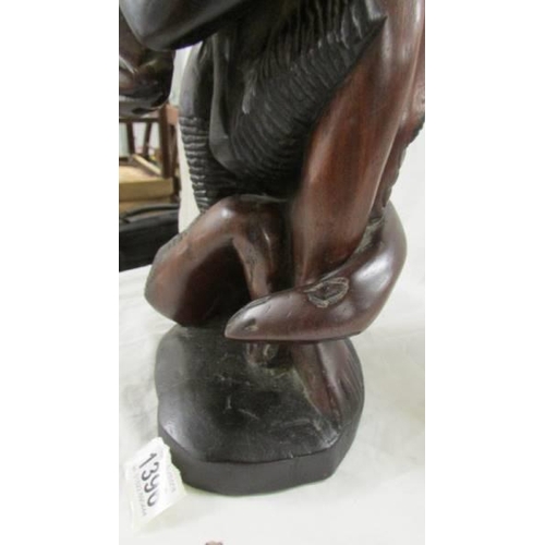 1396 - A good quality carved hardwood figure group with snake, 54 cm tall.