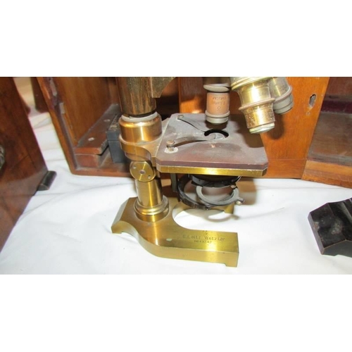 1408 - A cased brass microscope marked E Leitze Wetzlar, No. 49242.